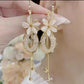 Elegante hangoorbellen met bloemen en kwastjes